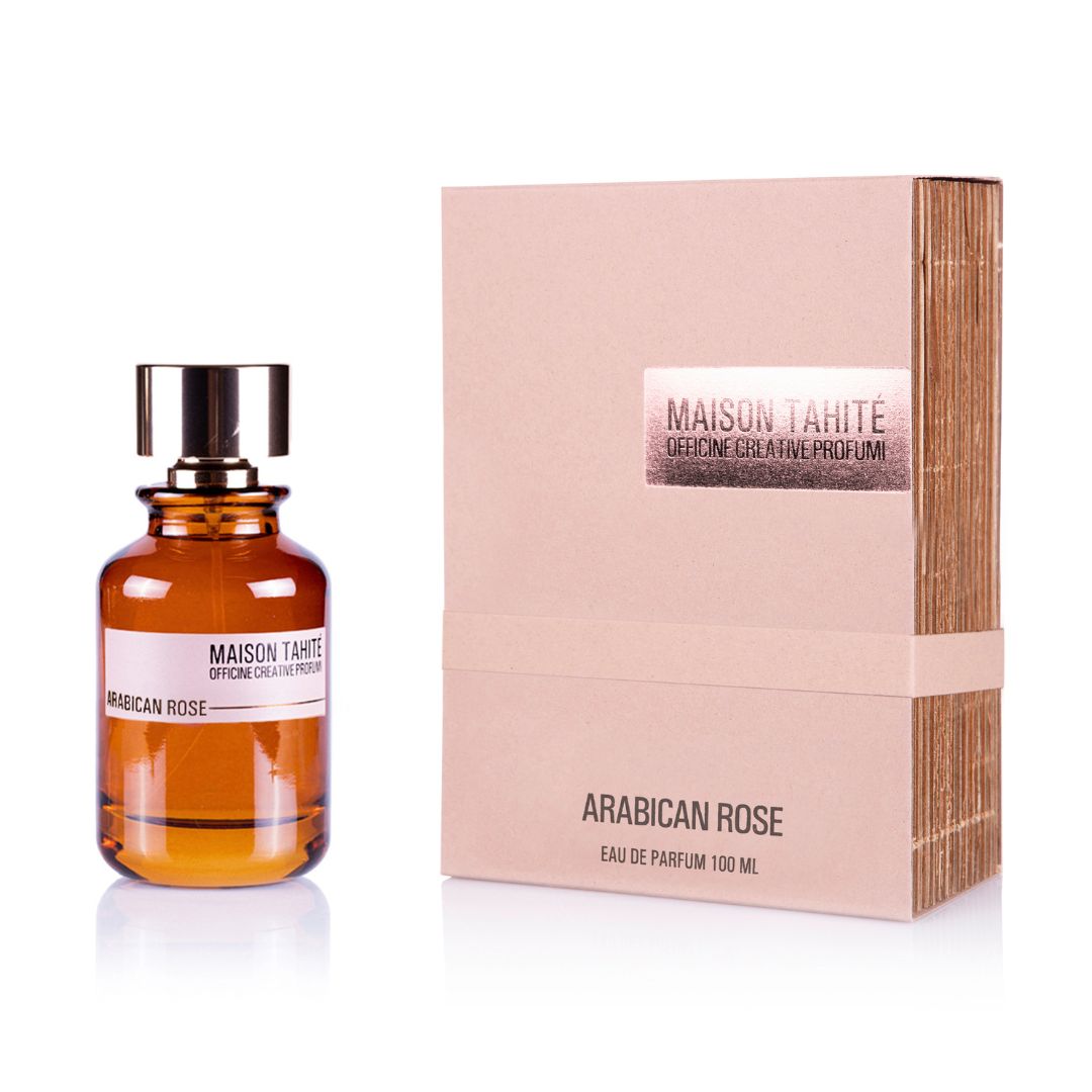 A Maison Tahite Arabican Rose Eau de Parfum 100ml bottle, in brown glass with a gold cap, sits next to its beige, metallic-accented box. The packaging reflects the fragrance’s exquisite, oriental-inspired luxury.