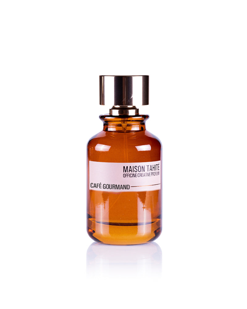 Café Gourmand Eau de Parfum by Maison Tahité comes in a brown glass bottle with a shiny gold cap. Its rich scent evokes hazelnut coffee and smoky wood, perfect for lovers of warm, inviting aromas.