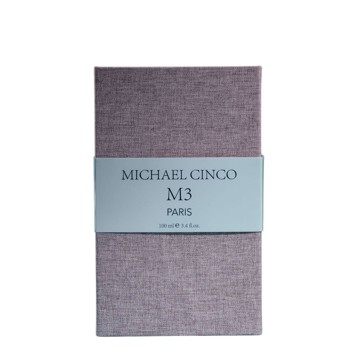 A rectangular box with a textured lavender surface and a light gray label reading Fragrapedia Haus M3 Eau de Parfum 100 ml, suggesting a floral scent created by Michael Cinco with consciously sourced ingredients.