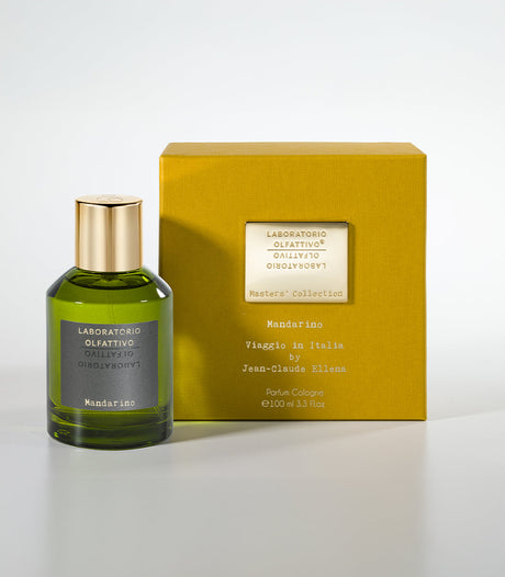 A green glass bottle of Laboratorio Olfattivo’s Mandarino Eau de Parfum with a gold cap stands beside its yellow box, which displays the perfume’s name and details in black—a long-lasting citrus scent.