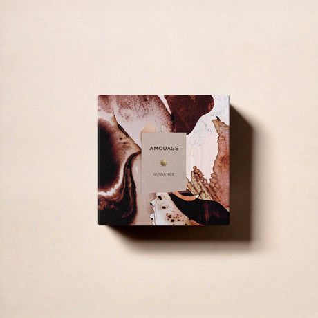 The square box of Fragrapedia Haus Guidance Eau de Parfum features an abstract brown and cream marbled design on a light beige background.
