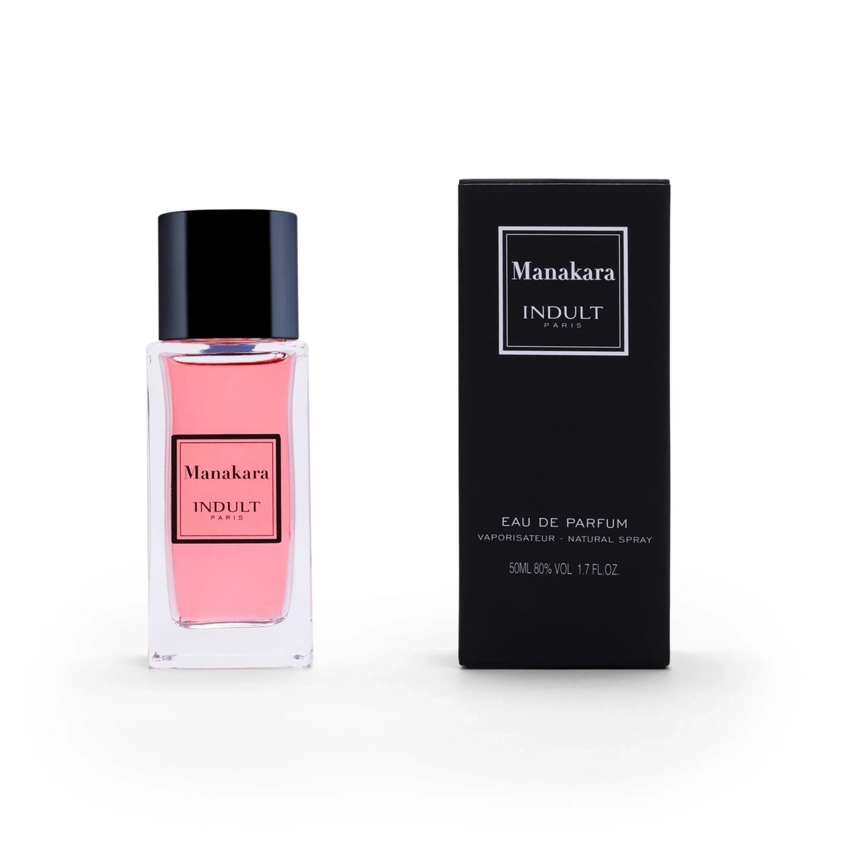 A bottle of Manakara Eau de Parfum by Fragrapedia Haus, with pink liquid, is shown beside its black box; both have minimalist white and black labels. This 50 ml lychee and Damascena rose scent is an Eau de Parfum.