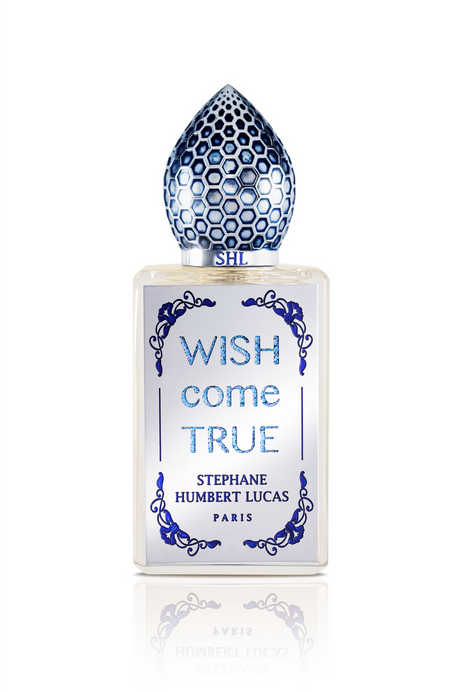 Wish Come True Eau de Parfum by Fragrapedia Haus features a frosted glass bottle adorned with blue, honeycomb-patterned cap and ornate designs, capturing the allure of a magic potion and feminine elegance.