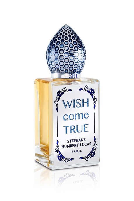 Wish Come True Eau de Parfum by Fragrapedia Haus showcases gold-hued liquid and a striking blue honeycomb cap, capturing the allure of a magical potion in this Stephane Humbert Lucas fragrance.