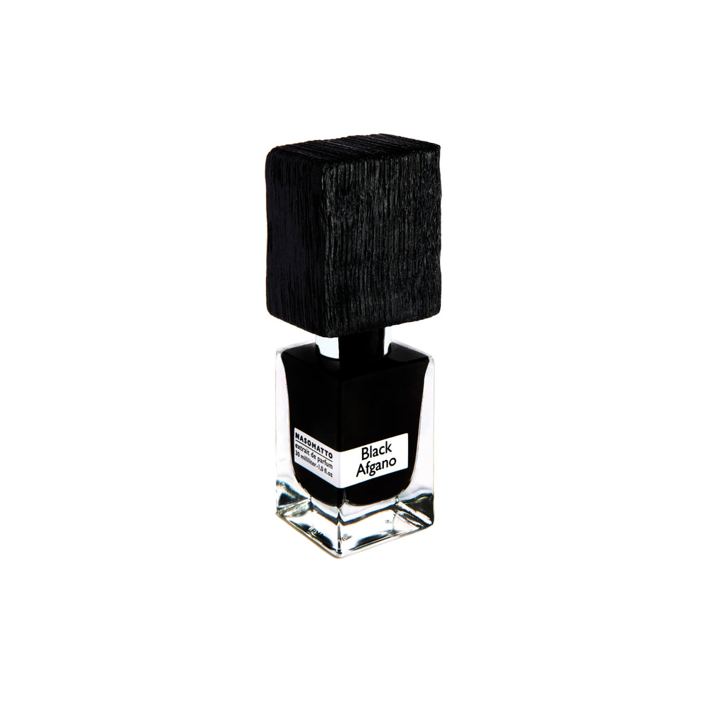 A clear glass bottle with a large textured black cap and label reading Black Afgano Extrait de Parfum by Fragrapedia Haus evokes bold hashish notes, set against a white background.