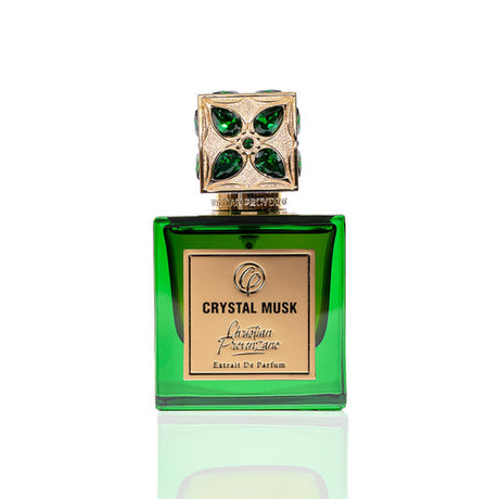 A green colored perfume bottle with a decorative cap featuring emerald stones, labeled 'CRYSTAL MUSK EDP'.
