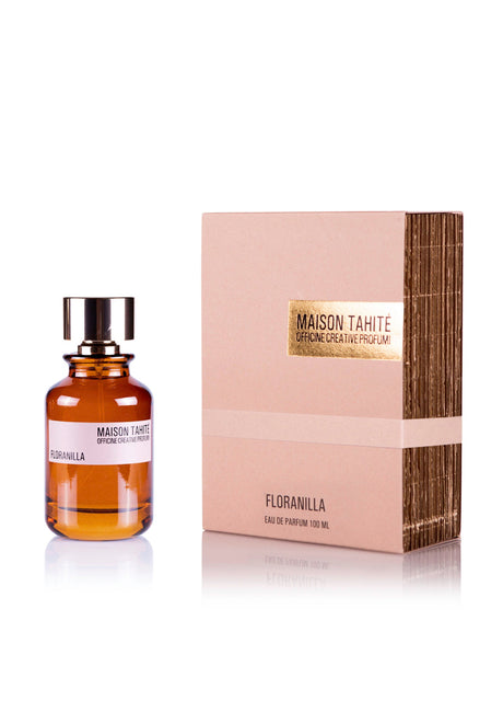A 100 mL bottle of Maison Tahite's Floranilla Eau de Parfum sits beside its beige and gold branded box, both featuring the product name. The scent is enriched with vanilla absolute.