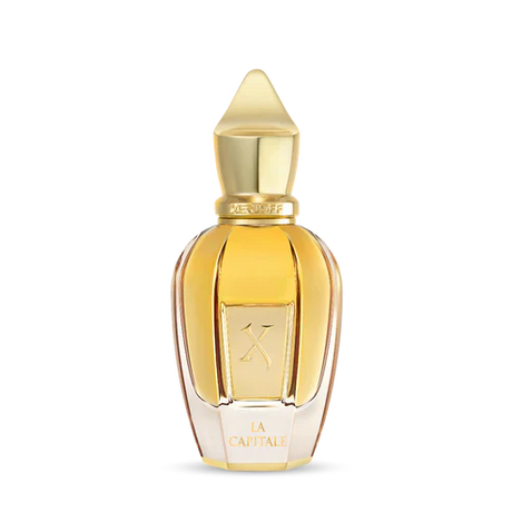 A gold-capped, faceted bottle of amber liquid displays a K and "La Capitale." La Capitale Eau de Parfum by Fragrapedia Haus exudes sophistication in its transparent design.