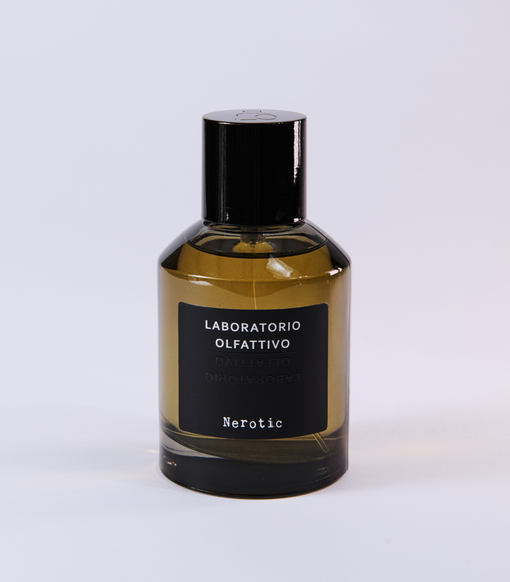 A green glass bottle of Nerotic Eau de Parfum by Laboratorio Olfattivo, with a black cap and label, sits on a white background. This unisex fragrance features masculine notes.