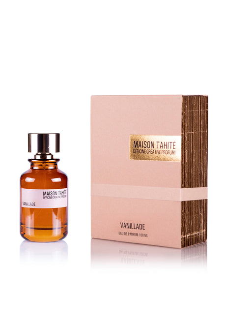 Vanillade Eau de Parfum by Maison Tahite, featuring a brown cap, is shown beside its beige and gold box. The packaging highlights the brand, while the scent offers elegant benzoin notes.