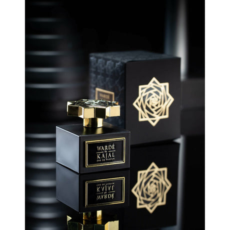Warde EDP 100ml by Kajal Perfumes. Black cube bottle with gold logo and gold lid. Black carton box embossed with a black flower pattern to one side and a black and gold flower to the other side.
