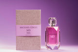A bottle of Fragrapedia Haus M5 Eau de Parfum by Michael Cinco stands next to its textured beige and lavender box, both set against a gradient purple background. The faceted bottle with a clear cap suggests the seductive fragrance inside.