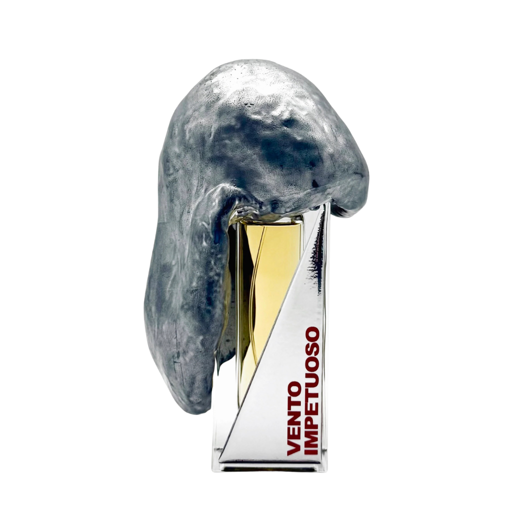 A bottle of perfume with a unique gray sculptural design next to it on a white background.