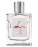 A clear glass bottle with a shiny silver cap, featuring a textured white label with Annicke 4 Eau de Parfum - Eight and Bob by Fragrapedia Haus. The light pink liquid inside suggests its floral fruity scent.
