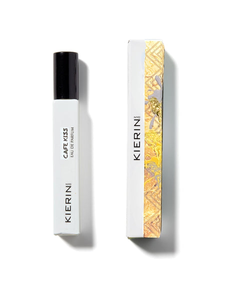 A white rectangular perfume bottle labeled Cafe Kiss Eau de Parfum - Kierin by Fragrapedia Haus lies beside its matching gold and white box—a perfect choice for fans of cozy scents and gourmand fragrances.