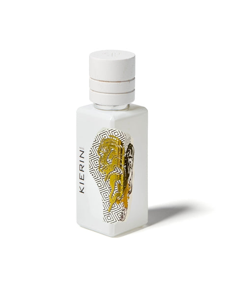 A white perfume bottle with a white cap, displaying the brand Fragrapedia Haus and Cafe Kiss Eau de Parfum, features a gold and black abstract front design—ideal for cozy scent or gourmand perfume lovers, set against a plain white background.