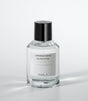 A clear glass bottle of NEED U Eau de Parfum by Laboratorio Olfattivo, with a black cap and labeled branding, rests on a white surface—an elegant unisex fragrance with soft jasmine notes.