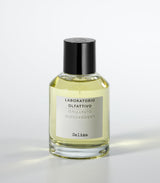 A clear glass bottle of Salina Eau de Parfum by Laboratorio Olfattivo, filled with yellow liquid and topped with a black cap, stands against a white background, capturing the fresh aquatic allure of this signature scent.