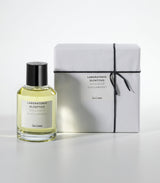 A clear glass bottle of Salina Eau de Parfum by Laboratorio Olfattivo stands beside a white, black-string-tied gift box, both set against a plain white background.