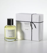 A bottle of Salina Eau de Parfum by Laboratorio Olfattivo stands beside a white gift box tied with black string, both labeled with the brand and fragrance name, on a plain light gray background.