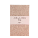 A beige textured rectangular box with a white band labeled Fragrapedia Haus M1 Eau de Parfum 100 ml, exuding a refined floral fragrance of rose and jasmine.