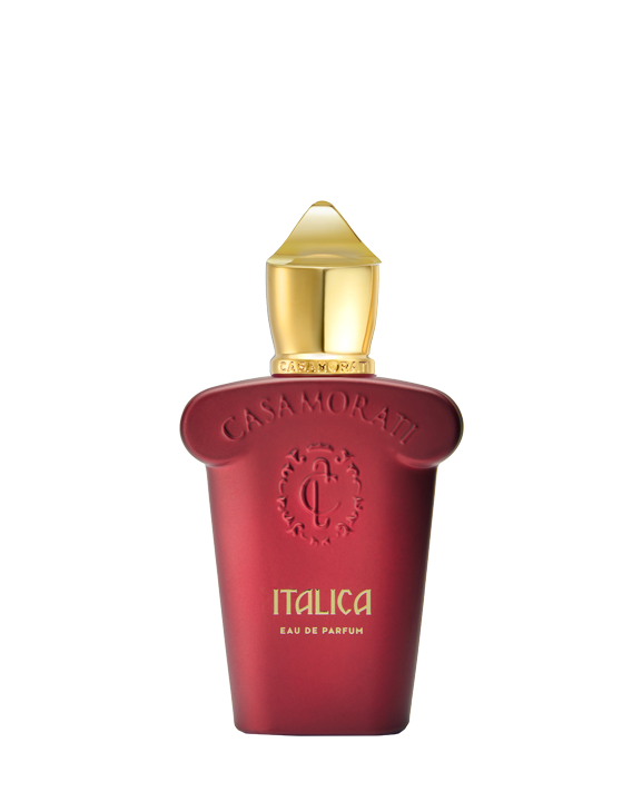 A red bottle with a gold cap and embossed “Casamorati” logo showcases Italica Eau de Parfum - Xerjoff by Fragrapedia Haus, suggesting a luxurious Italian almond fragrance against a white background.