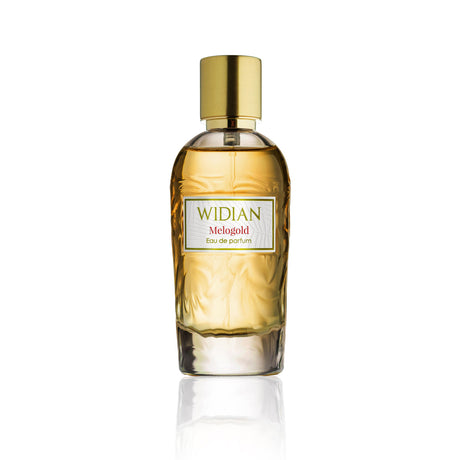 A clear glass bottle of Melogold Eau de Parfum by Fragrapedia Haus, featuring golden liquid, a shiny gold cylindrical cap, and vibrant grapefruit-leather notes, is displayed against a white background.