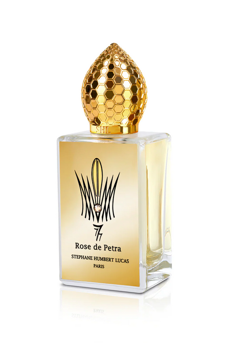 Rose de Petra Eau de Parfum by Fragrapedia Haus features a rectangular bottle with a gold honeycomb-patterned cap and gold label, capturing the essence of Bulgarian Rose in this Stephane Humbert Lucas creation.