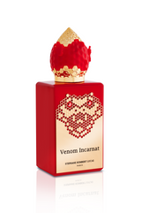 A red Venom Incarnat Eau de Parfum bottle by Fragrapedia Haus features a gold label with honeycomb design and a gold-red cap, evoking the allure of a love potion.
