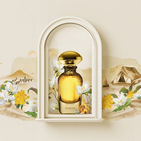 A gold bottle of Samar Extrait de Parfum - Widian by Fragrapedia Haus sits in a white arched niche, amid illustrated white and yellow flowers, desert scenery, camels, and a tent—reflecting the opulent oud aroma inside.