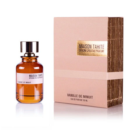 A brown glass bottle of Vanille de Minuit Eau de Parfum by Maison Tahite sits beside its beige and gold box, both showing the brand name and fragrance name.