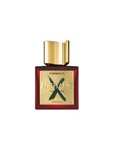A red bottle of Fragrapedia Haus Tuberoza X Extrait de Parfum by Nishane, with a gold cap and green X on the label, features Indian tuberose white florals. The bottle is set against a plain white background.