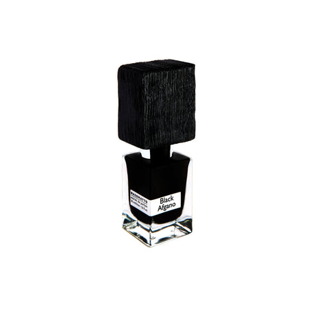 A clear glass bottle with a large textured black cap and label reading Black Afgano Extrait de Parfum by Fragrapedia Haus evokes bold hashish notes, set against a white background.