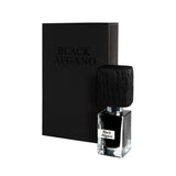 A bottle of Black Afgano Extrait de Parfum by Fragrapedia Haus with a black rectangular cap stands before a matching box labeled BLACK AFGANO, capturing the essence of a hashish-inspired fragrance.