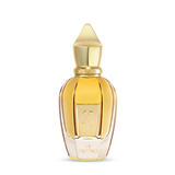 A gold-capped, faceted bottle of amber liquid displays a K and "La Capitale." La Capitale Eau de Parfum by Fragrapedia Haus exudes sophistication in its transparent design.