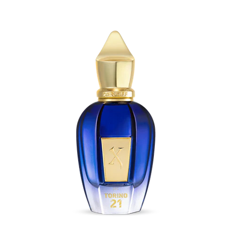 Torino 21 Eau de Parfum by Fragrapedia Haus features a blue and gold bottle with a pointed cap, gold label, and TORINO21 on the front—a luxurious design inspired by the vibrant energy of professional tennis.