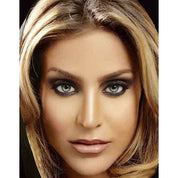 Picture of a blonde haired female with black kajal eyeliner around her eyes.