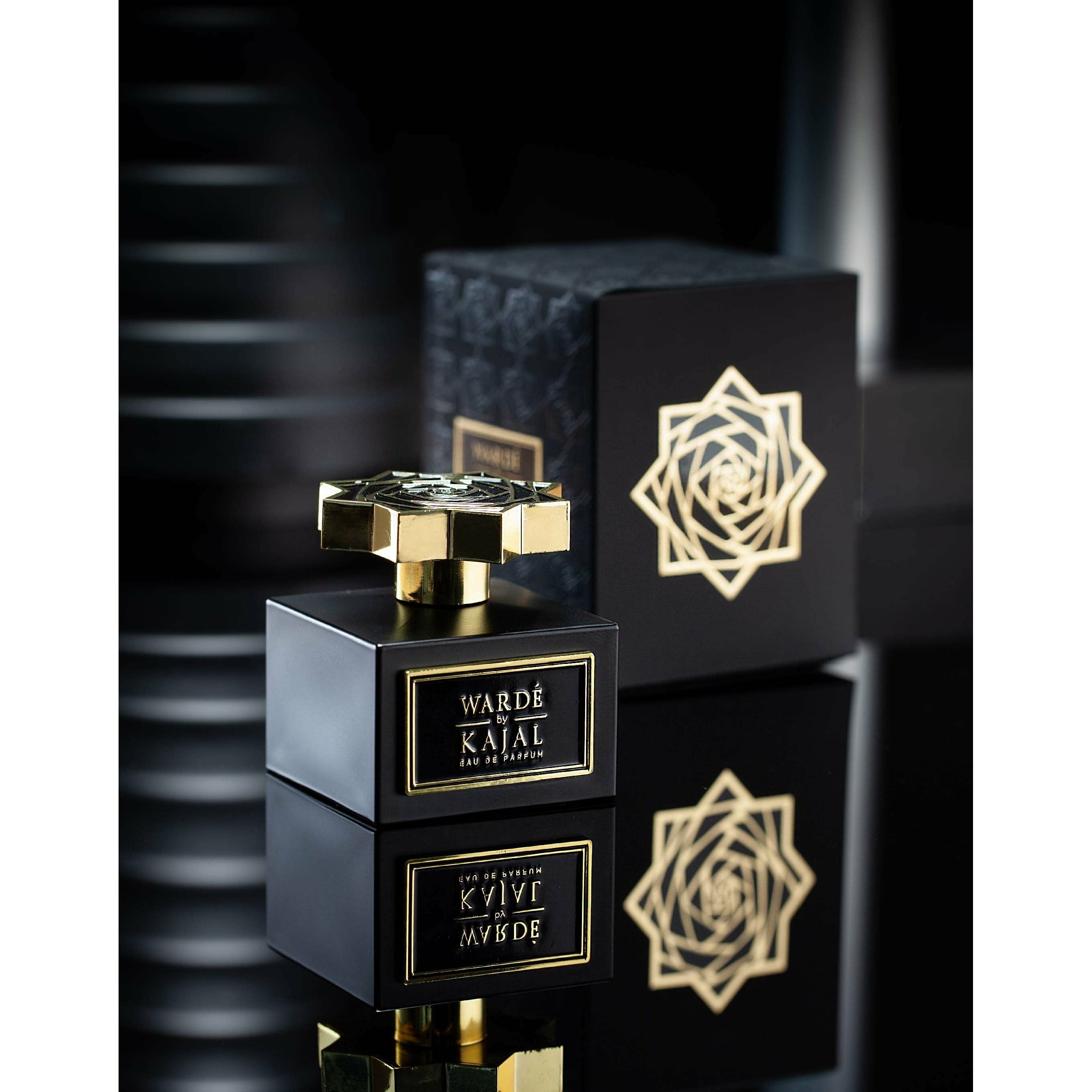 Warde EDP 100ml by Kajal Perfumes. Black cube bottle with gold logo and gold lid. Black carton box embossed with a black flower pattern to one side and a black and gold flower to the other side.